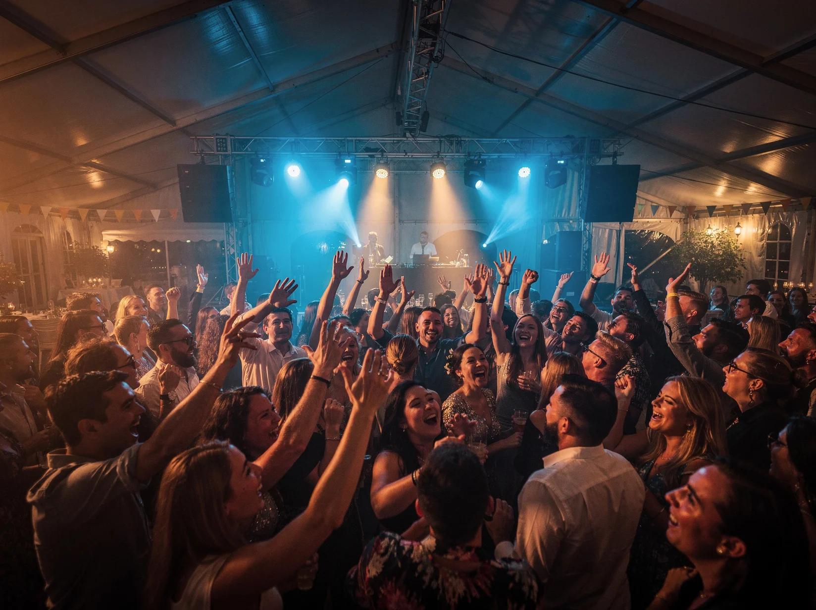 Festival crowd singing along to mainstream hits played by an afrobeats DJ