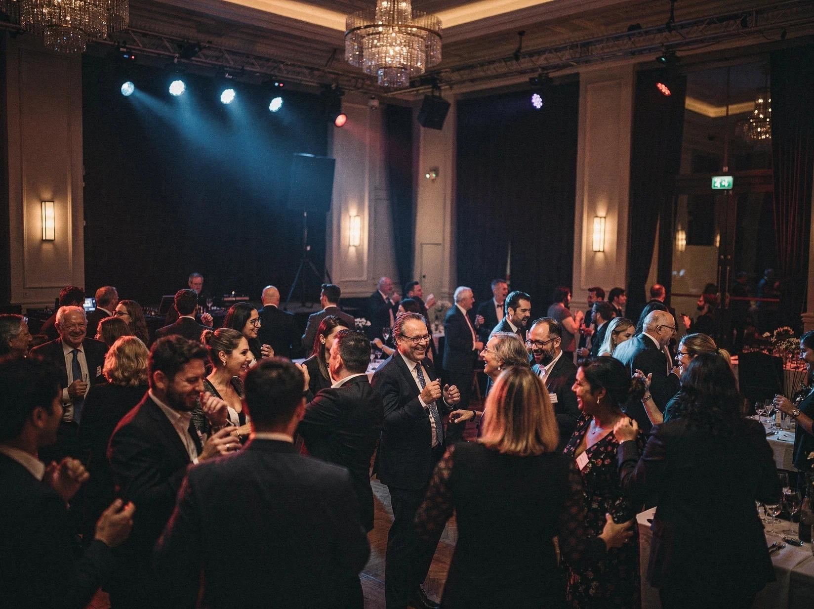 Internationaal gezelschap danst op een feest waar je een DJ kunt huren in Brussel