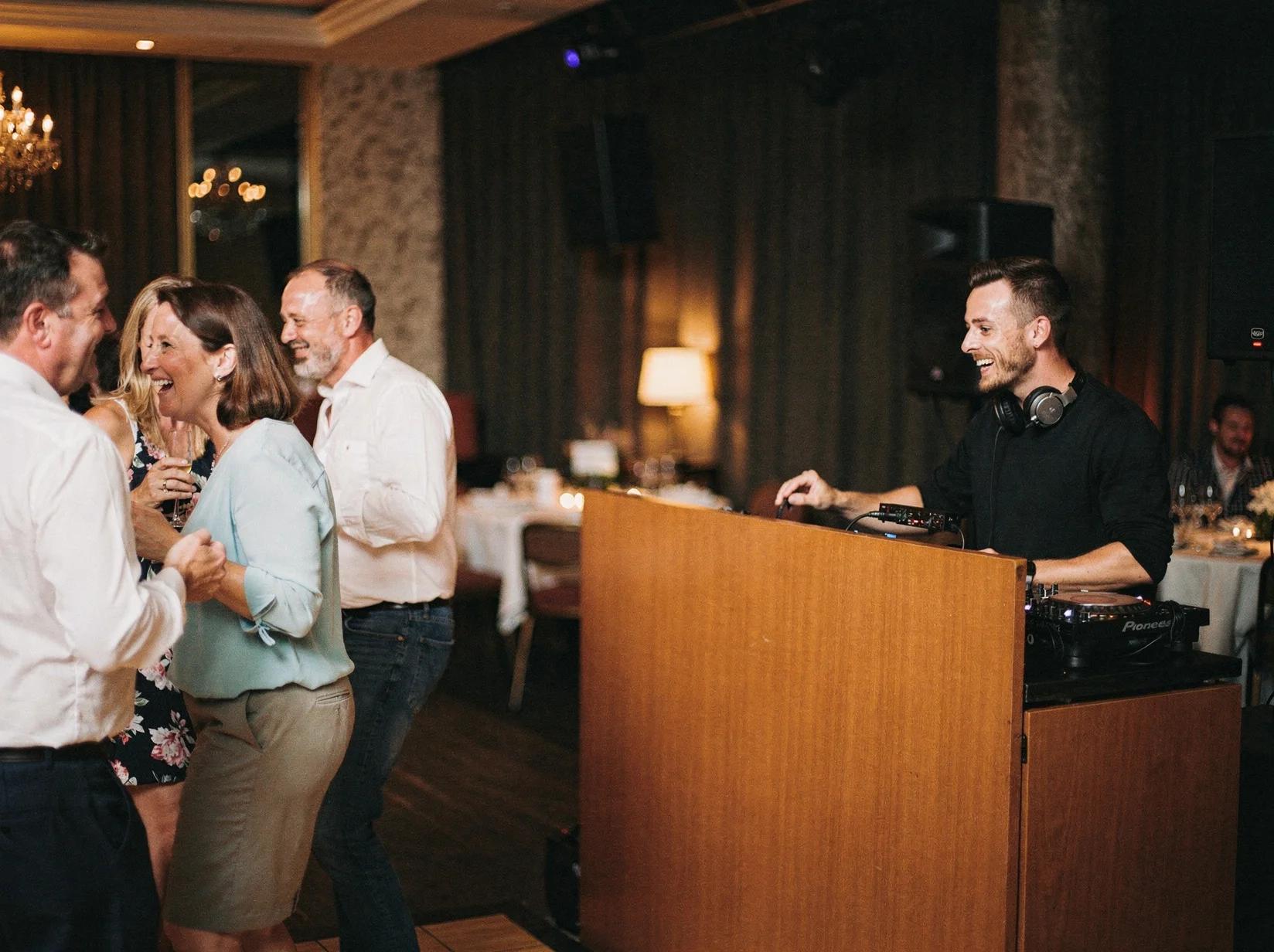 Guests mingling and relaxing to a lounge DJ at an atmospheric reception venue