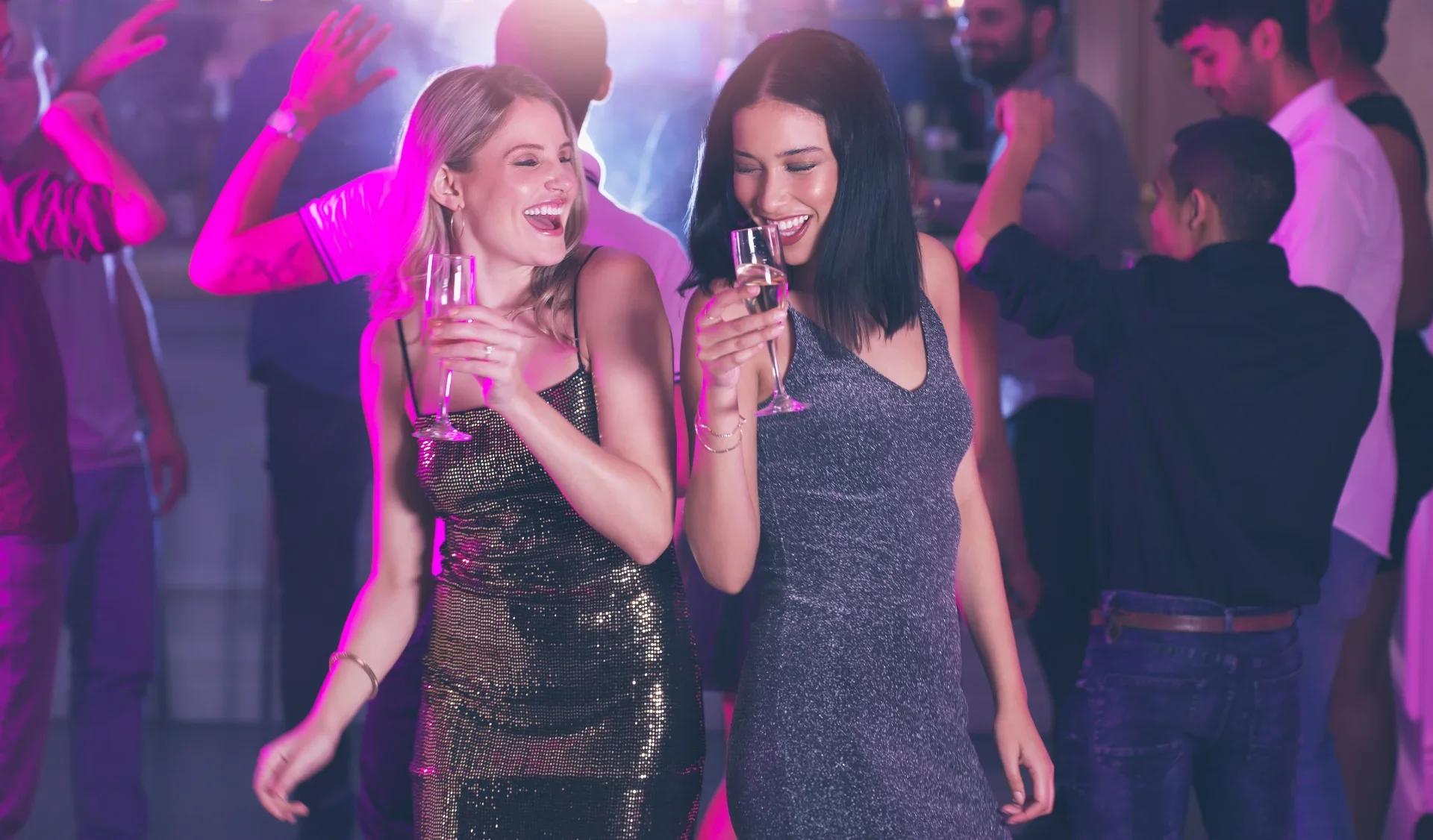 two happy women dancing and laughing at a vibrant 2026 09 25 04 55 43 utc